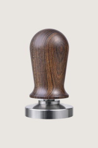 wooden and silver tamper tool on a beige background